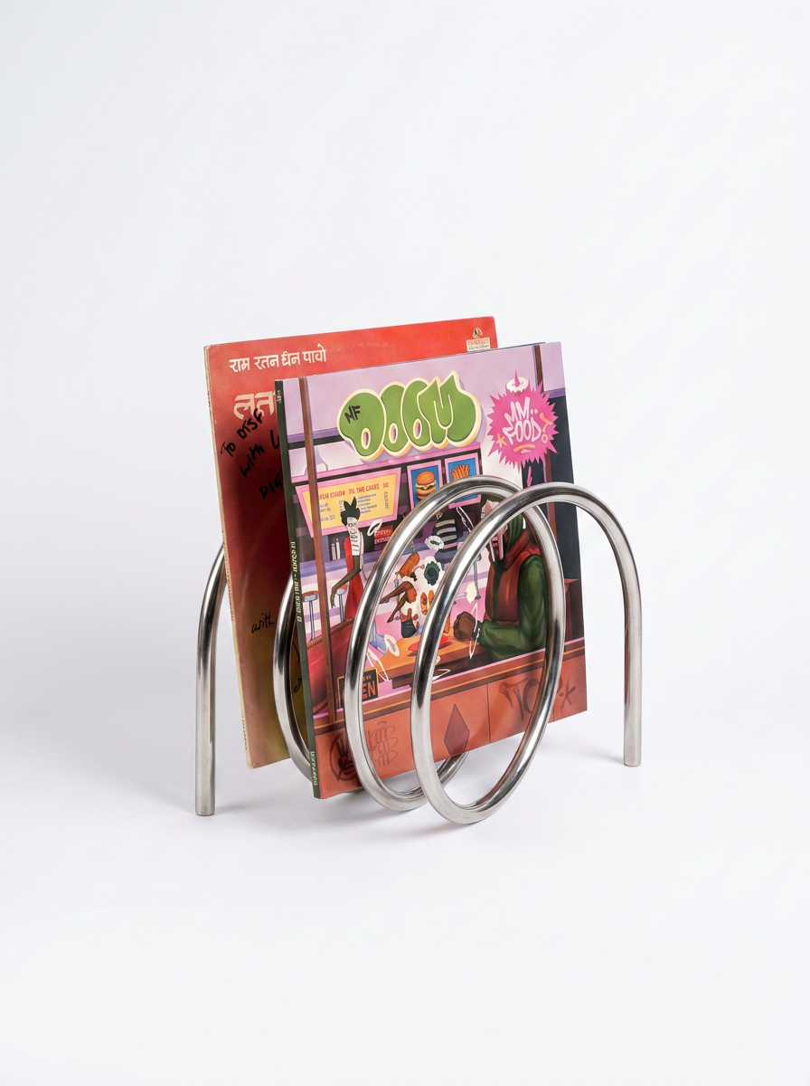 Human Error 001 Book Stand, a premium minimalist steel utility rest sitting on a modern studio workspace.